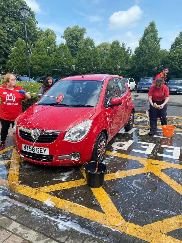 Our Prestbury House care home team members cleaning cars for charity.