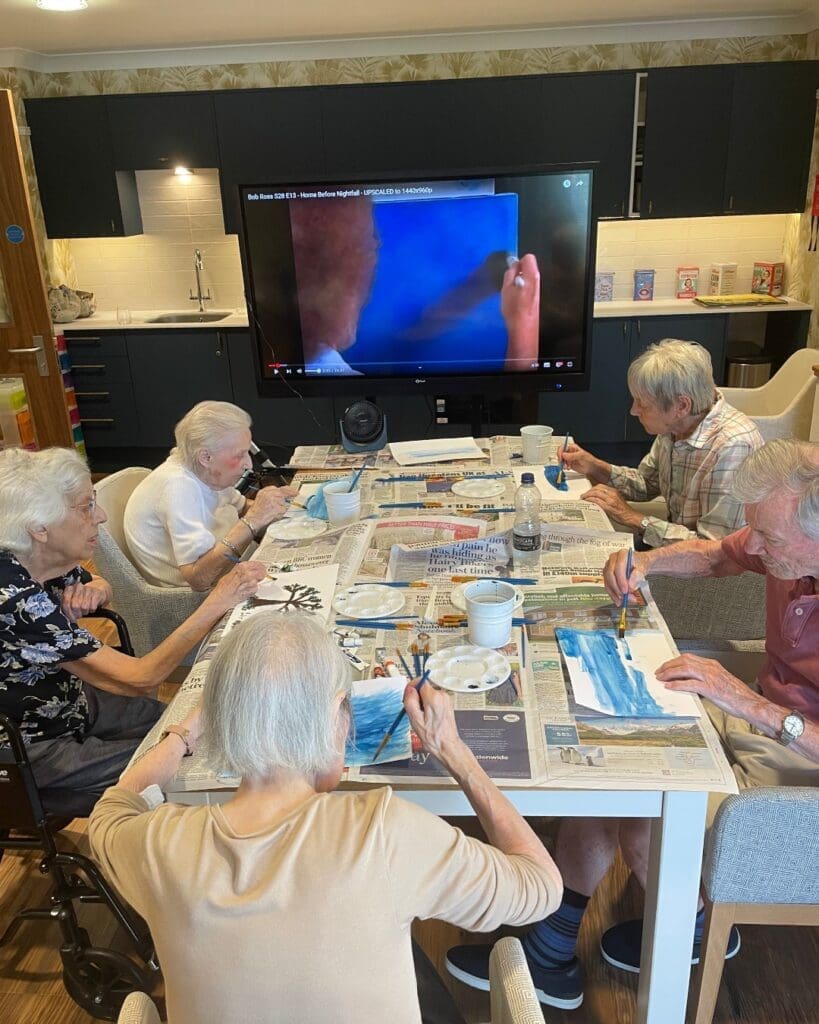 Residents of our Lea Grange care home in Hertfordshire enjoying some guided painting.