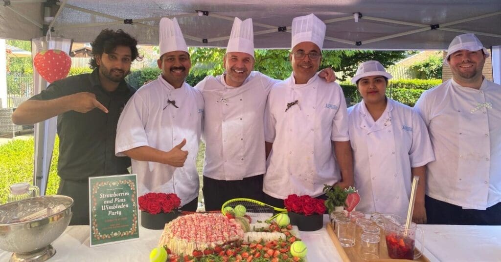 Our chefs at Avondale care home in front of a Wimbledon-themed cake that they baked.