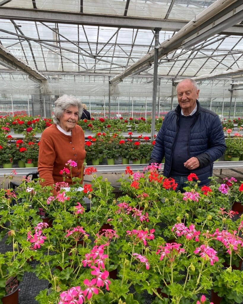Two of our Thirlestaine Park care home residents in the home’s greenhouse.